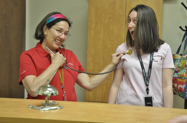 School nurse and student smiling.